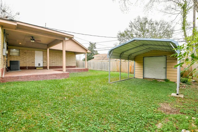 a backyard of a house with table and chairs