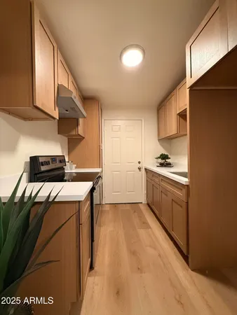 a kitchen with a stove cabinets and a refrigerator