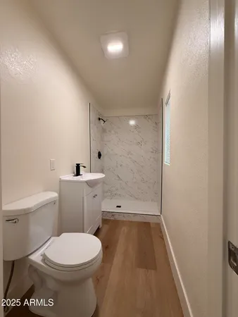 a bathroom with a toilet and a shower
