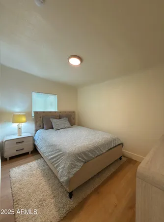 a bedroom with a bed and a lamp