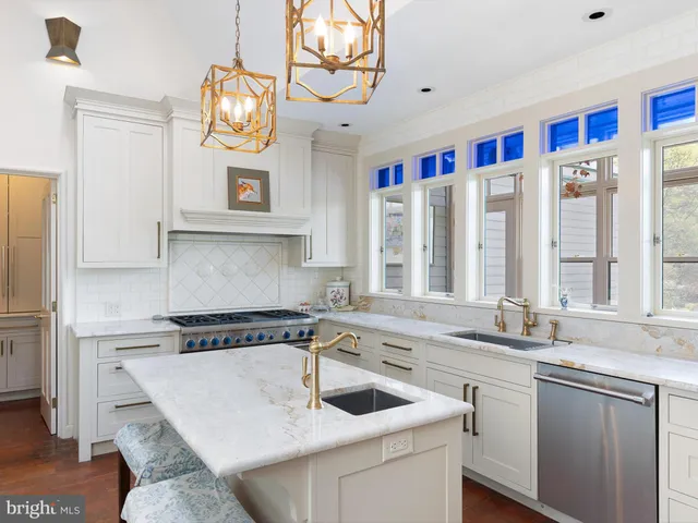 a kitchen with stainless steel appliances granite countertop a sink and a microwave