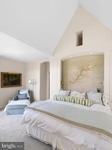 a bedroom with a bed and a mirror