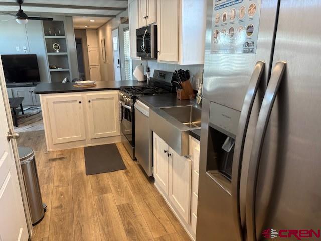 260 Southwest 13th Circle Cedaredge, CO 81413 - Photo 11 of 15 a kitchen with stainless steel appliances a refrigerator a sink a stove top oven a counter space and cabinets