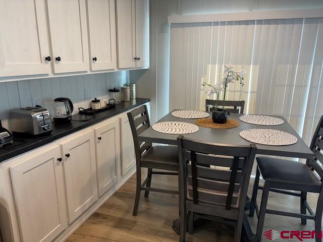 260 Southwest 13th Circle Cedaredge, CO 81413 - Photo 9 of 15 a kitchen with a table chairs and white cabinets