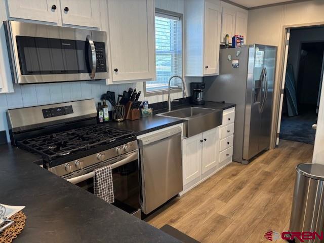 260 Southwest 13th Circle Cedaredge, CO 81413 - Photo 10 of 15 a kitchen with stainless steel appliances granite countertop a stove a refrigerator and a microwave