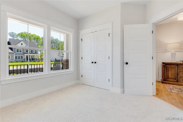 a view of a living room hardwood floor and a ceiling fan