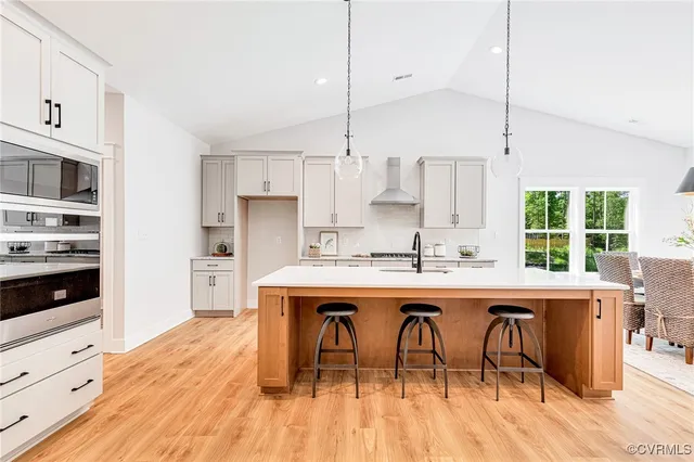 a living room with furniture a fireplace and kitchen view