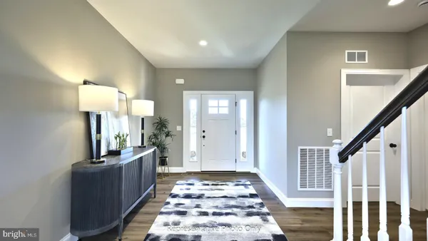 a view of a hallway with workspace and wooden floor