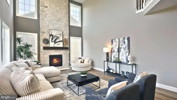 a living room with furniture fireplace and a large window