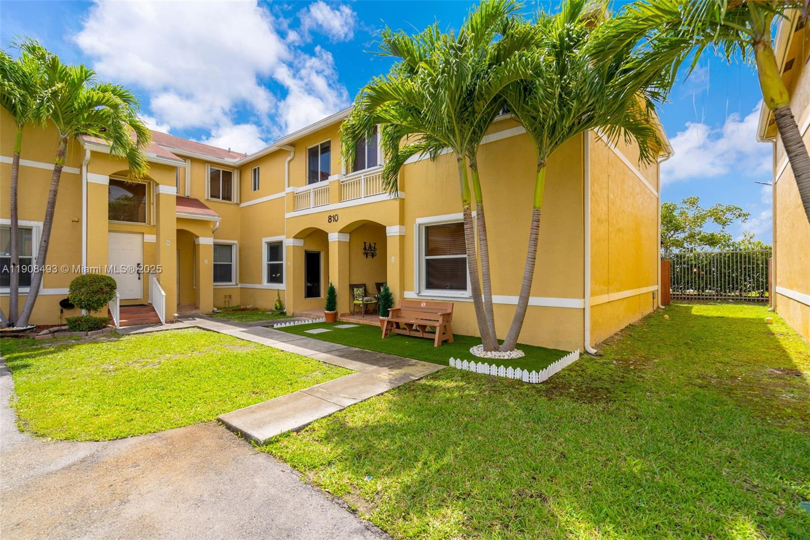 a view of backyard with swimming pool and seating space