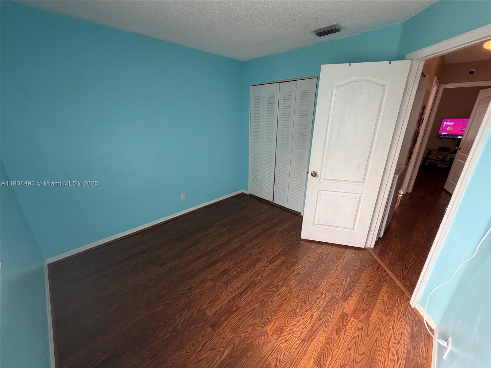 810 Northeast 212th Terrace, Unit 2 Miami, FL 33179 - Photo 16 of 44 an empty room with wooden floor