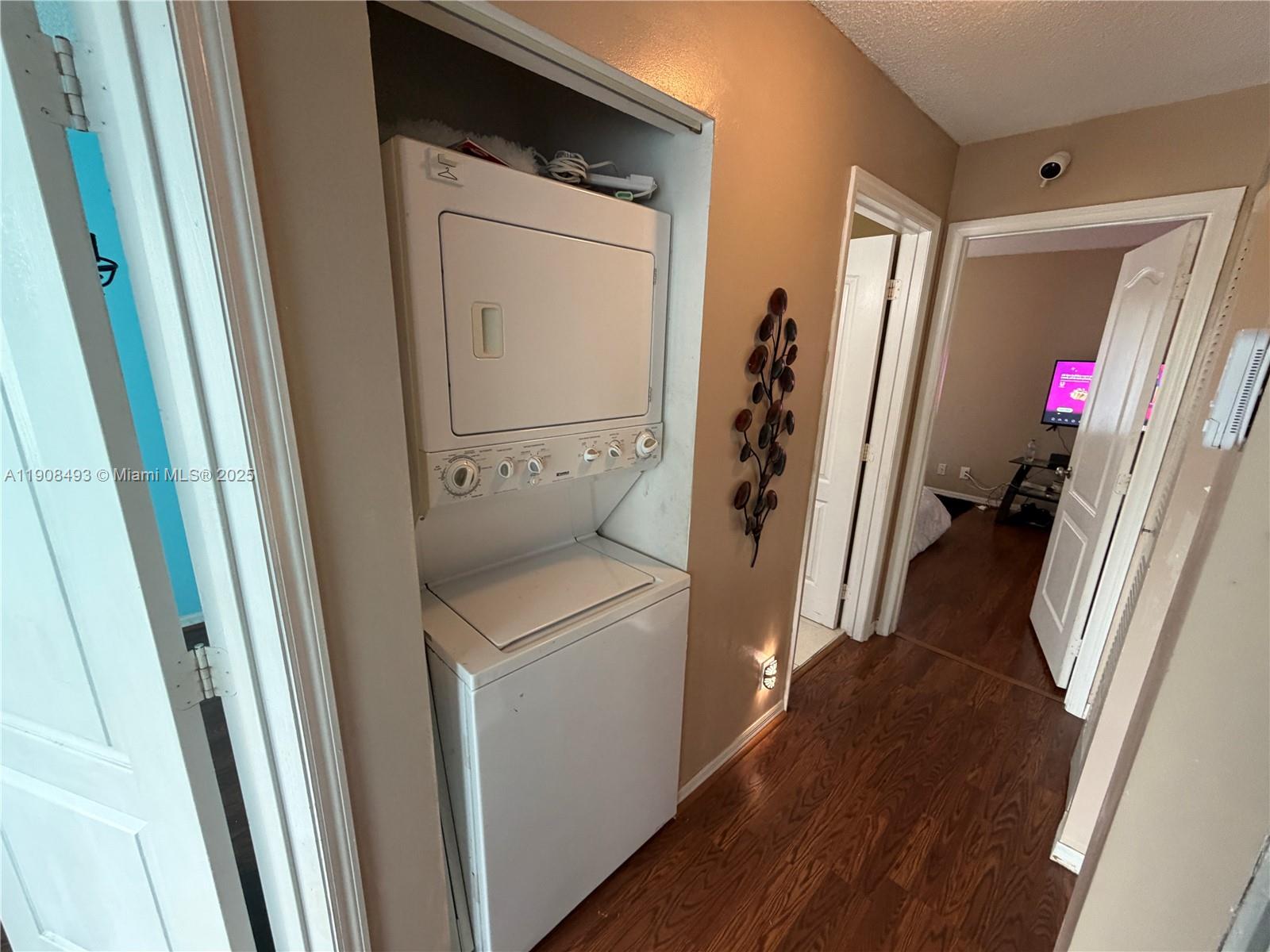 810 Northeast 212th Terrace, Unit 2 Miami, FL 33179 - Photo 18 of 44 a view of walk in closet with clothes and shoes