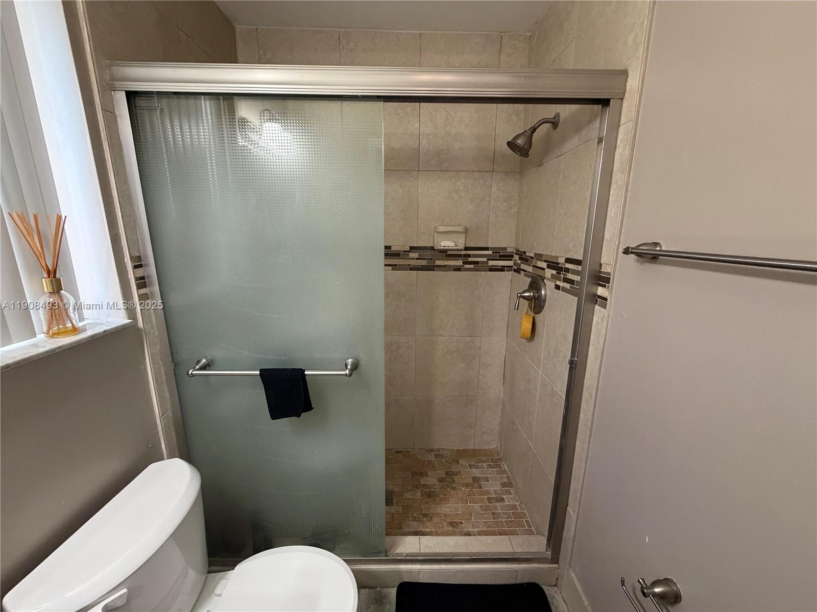 810 Northeast 212th Terrace, Unit 2 Miami, FL 33179 - Photo 23 of 44 a bathroom with a shower and a toilet