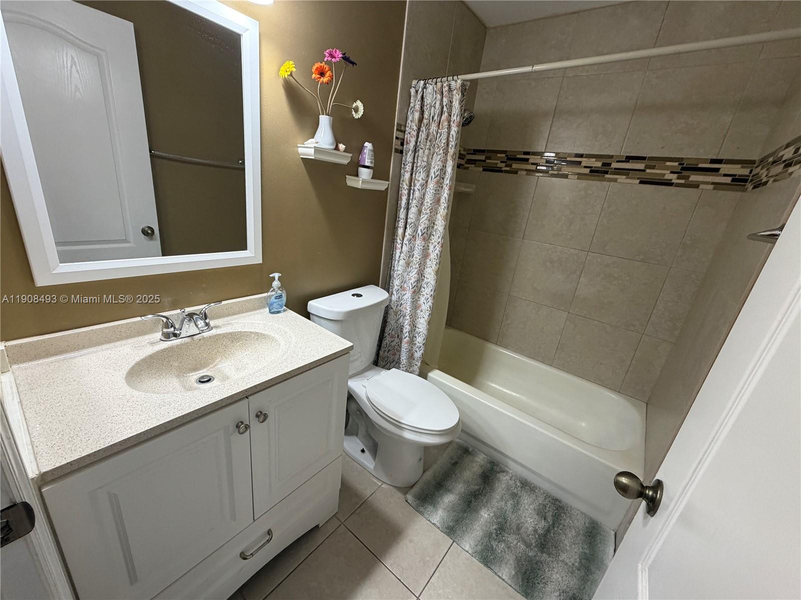 810 Northeast 212th Terrace, Unit 2 Miami, FL 33179 - Photo 31 of 44 a bathroom with a sink toilet and shower