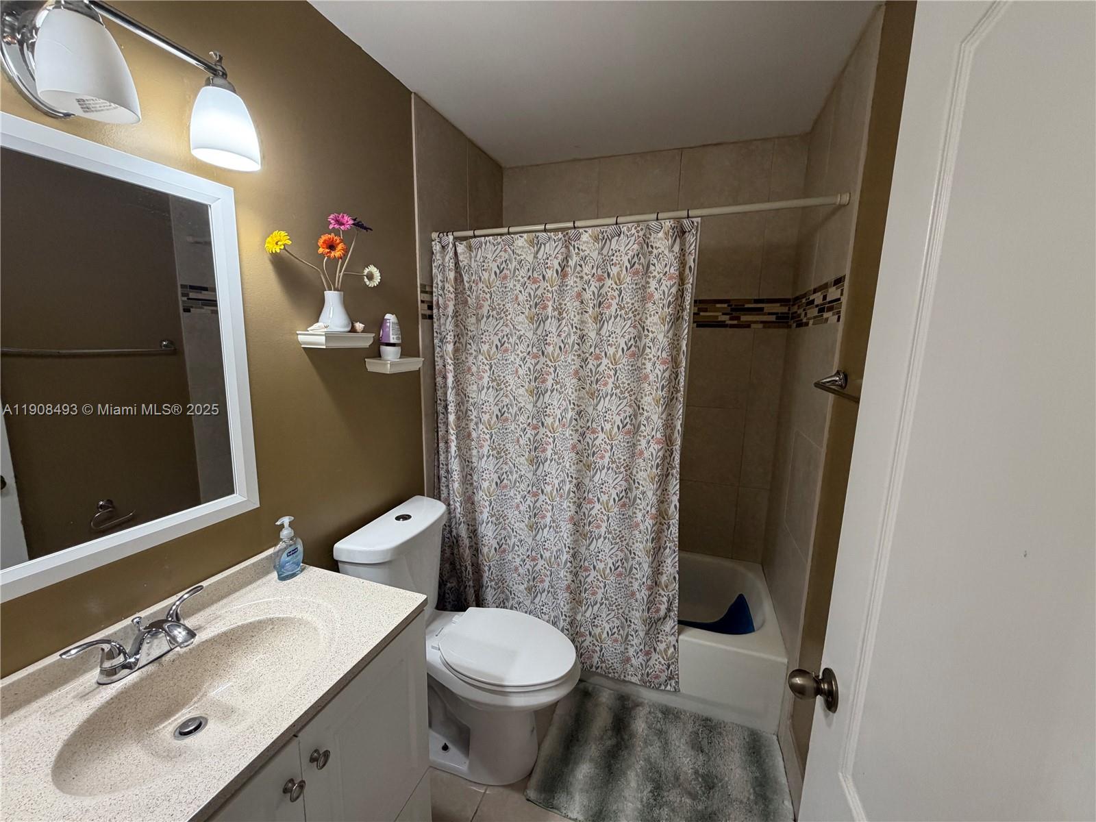 810 Northeast 212th Terrace, Unit 2 Miami, FL 33179 - Photo 32 of 44 a bathroom with a sink toilet and shower