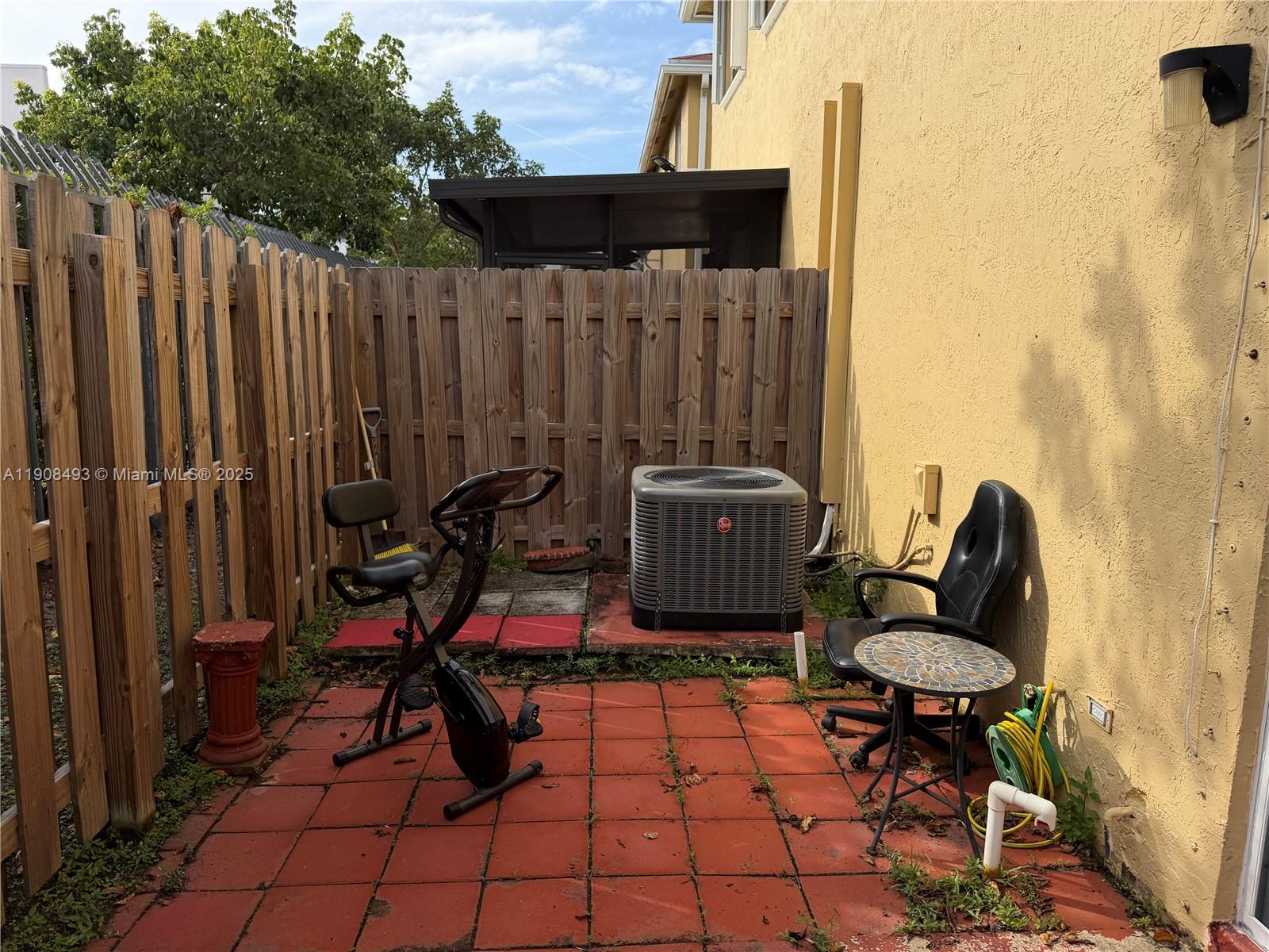 810 Northeast 212th Terrace, Unit 2 Miami, FL 33179 - Photo 39 of 44 a view of a chairs and tables in the patio