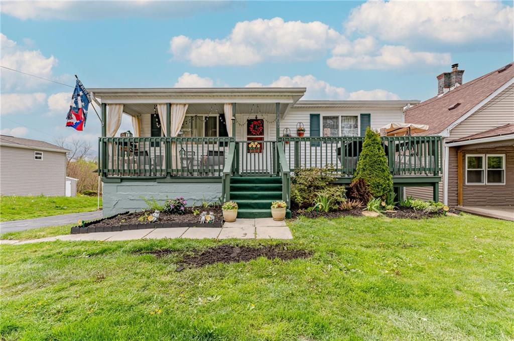 a front view of a house with a yard table and chairs