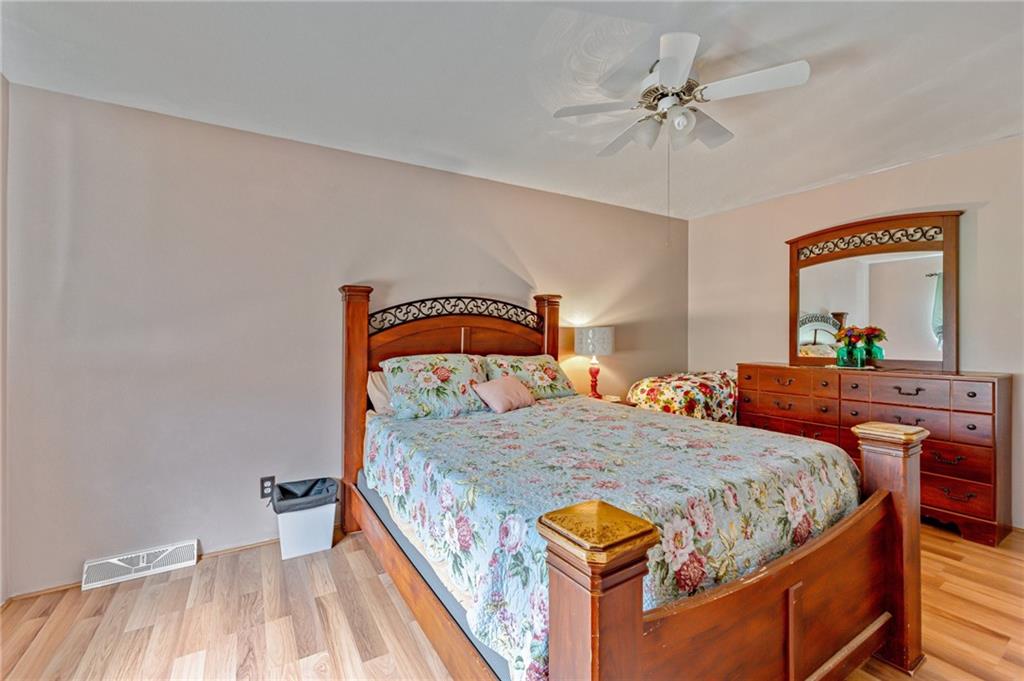 508 Joffre Bulger Road Joffre, PA 15053 - Photo 17 of 38 a bedroom with a bed and a chandelier