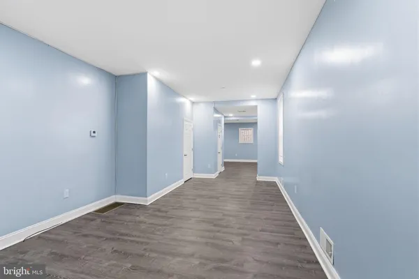 a view of hallway with wooden floor