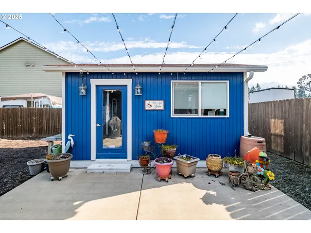 a living room with lots of furniture and clutter