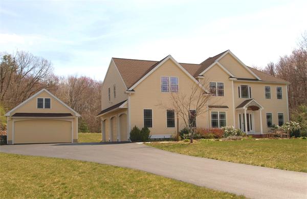 6 Spectacle Hill Road Bolton, MA 01740 - Photo 2 of 28 a front view of a house with a yard and garage