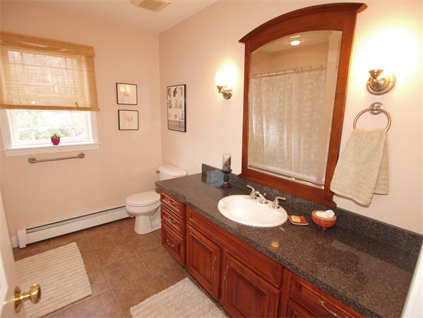6 Spectacle Hill Road Bolton, MA 01740 - Photo 25 of 28 a bathroom with a granite countertop sink toilet and mirror