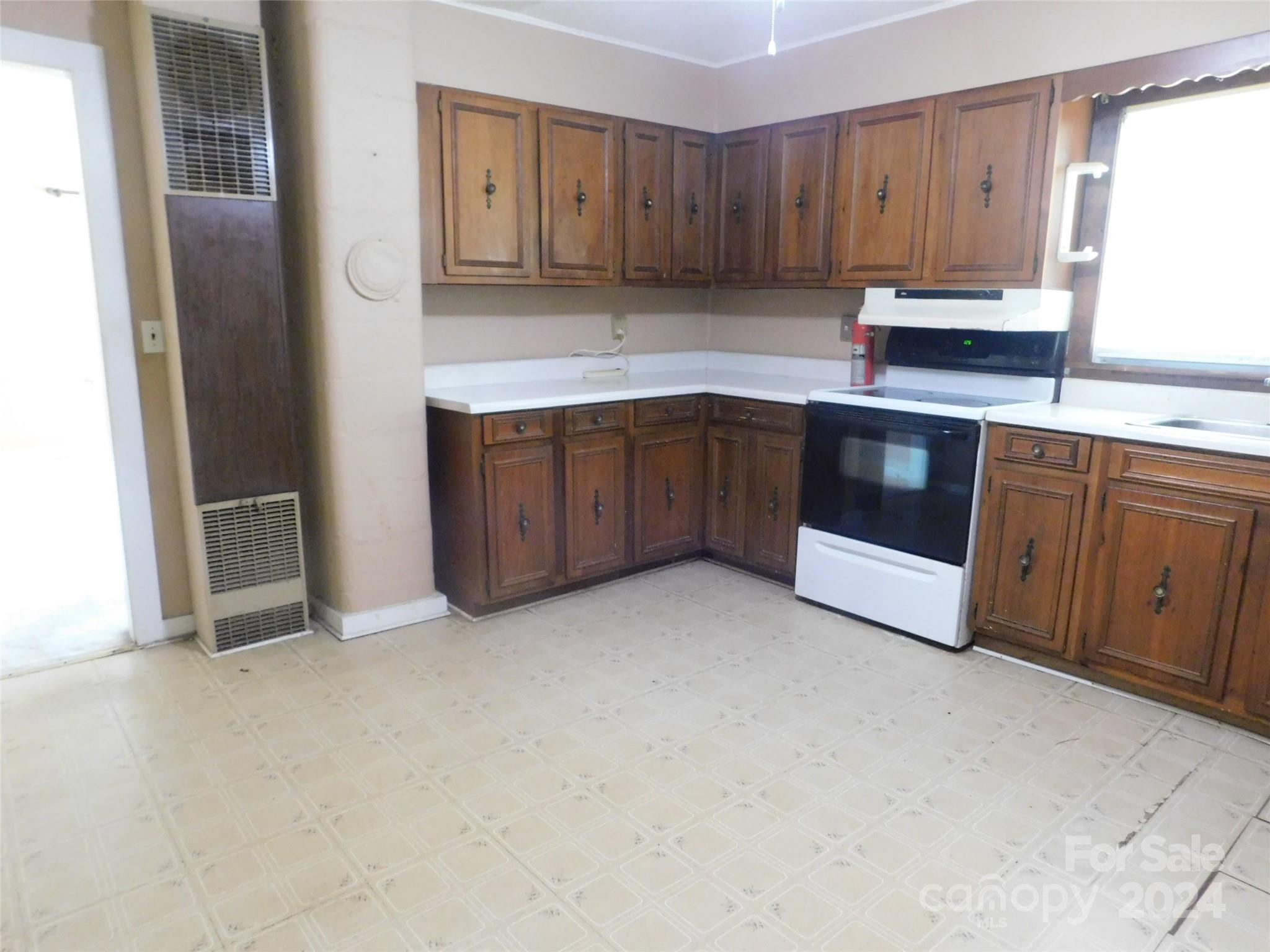 146 Browning Road Waynesville, NC 28786 - Photo 16 of 32 a kitchen with cabinets and white appliances