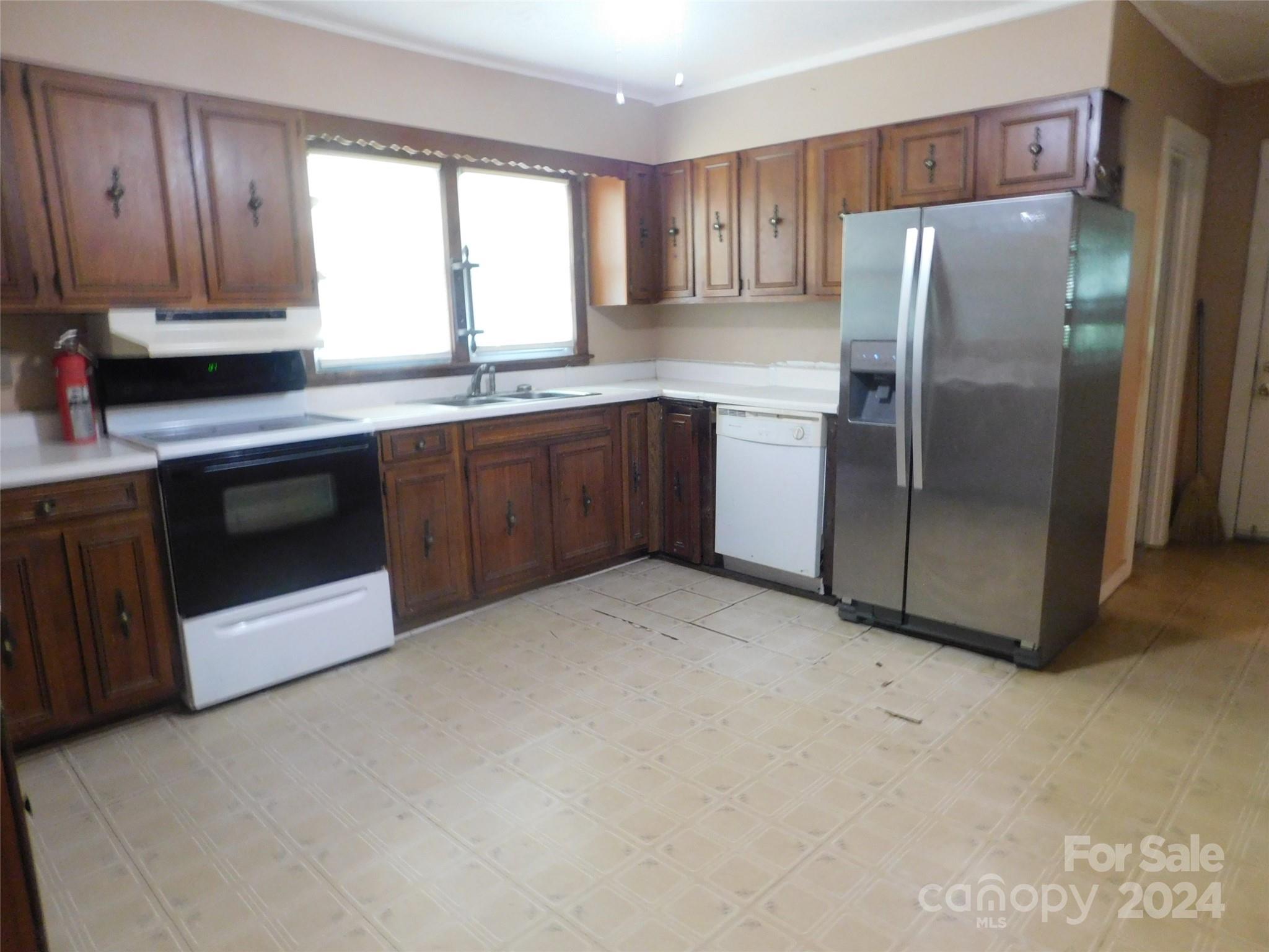146 Browning Road Waynesville, NC 28786 - Photo 18 of 32 a kitchen with stainless steel appliances granite countertop a refrigerator a sink a stove a microwave and cabinets