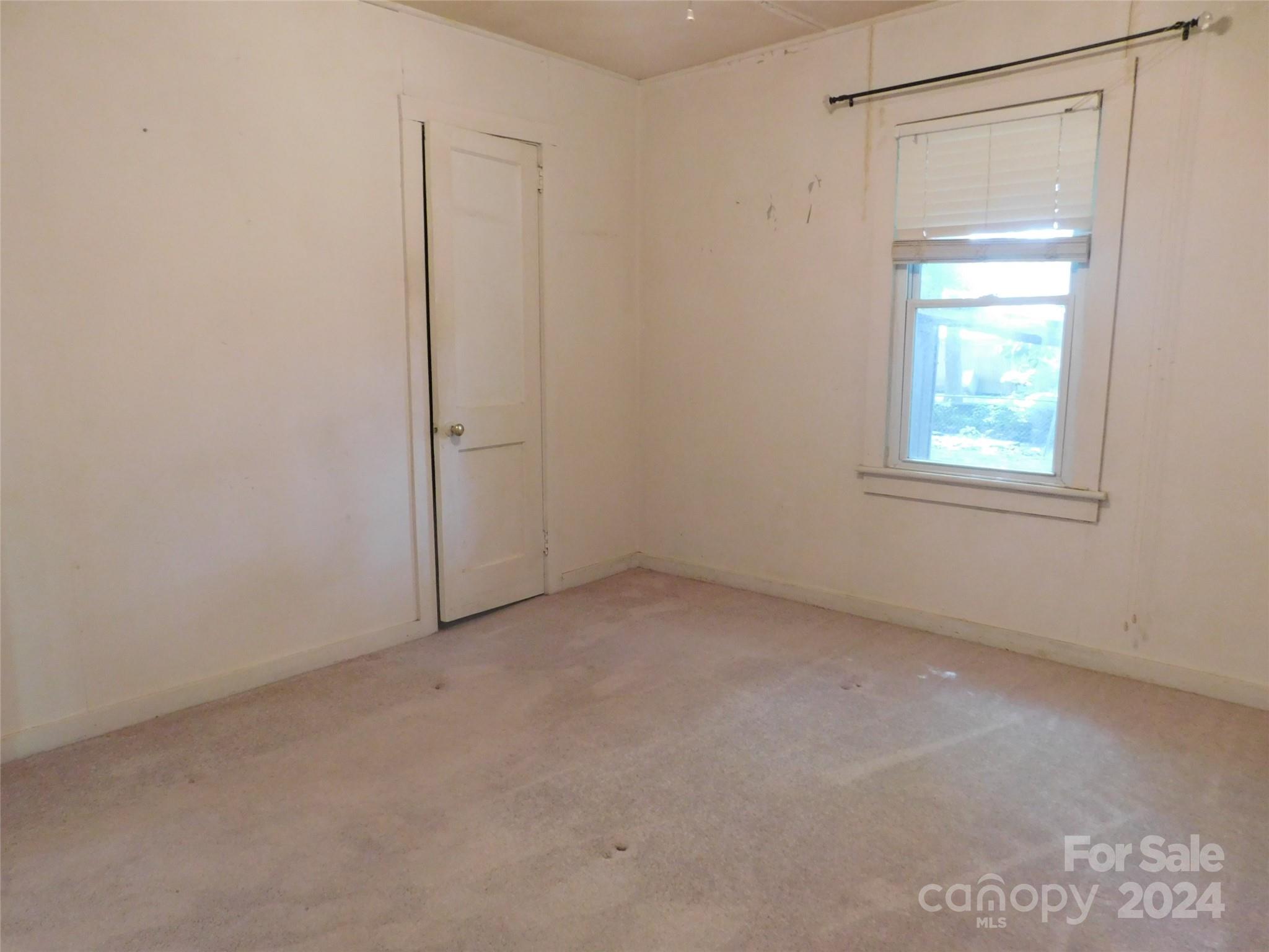 146 Browning Road Waynesville, NC 28786 - Photo 23 of 32 an empty room with windows and closet