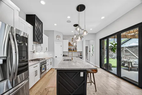 a kitchen with stainless steel appliances granite countertop a sink and cabinets