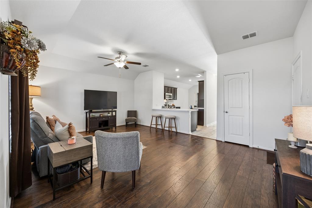 406 Madrone Lane Princeton, TX 75407 - Photo 4 of 30 Open concept living area featuring wood-finish flooring, white walls, and a ceiling fan with integrated lighting