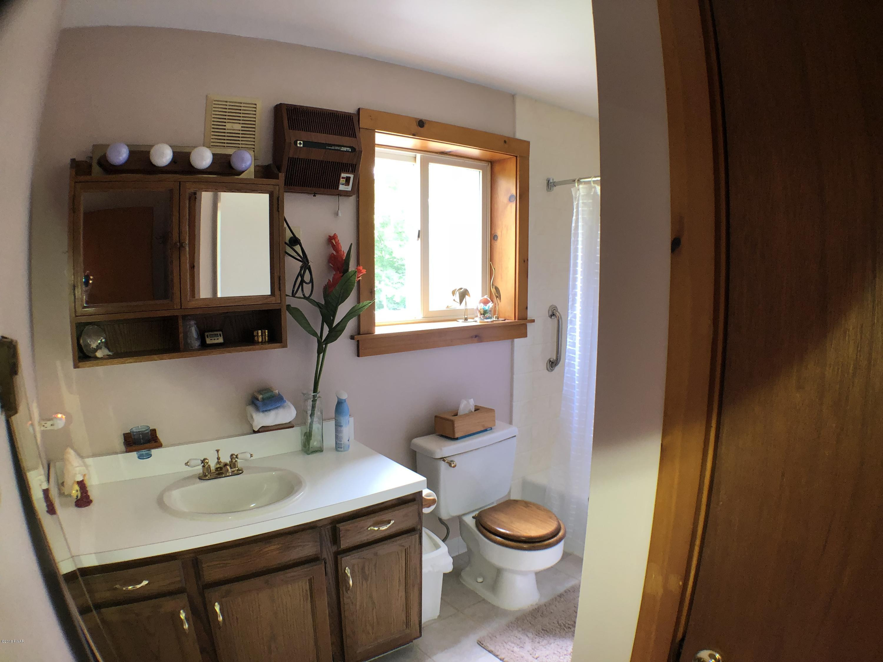 57 Log Road Lake Ariel, PA 18436 - Photo 12 of 18 a bathroom with a toilet sink and mirror