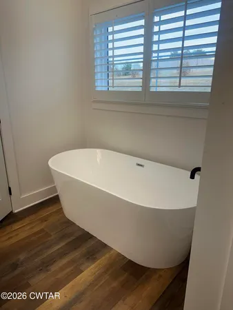 a white tub sitting in a bathroom
