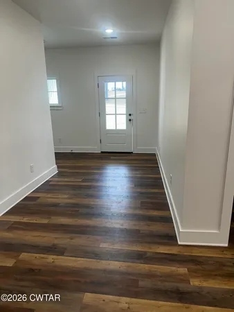 a view of wooden floor and windows in a room