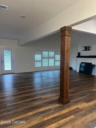 a view of an empty room and wooden floor