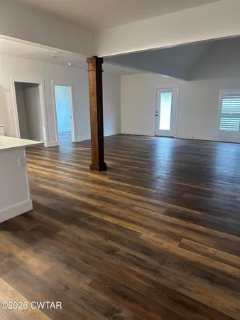 a view of a room with wooden floor