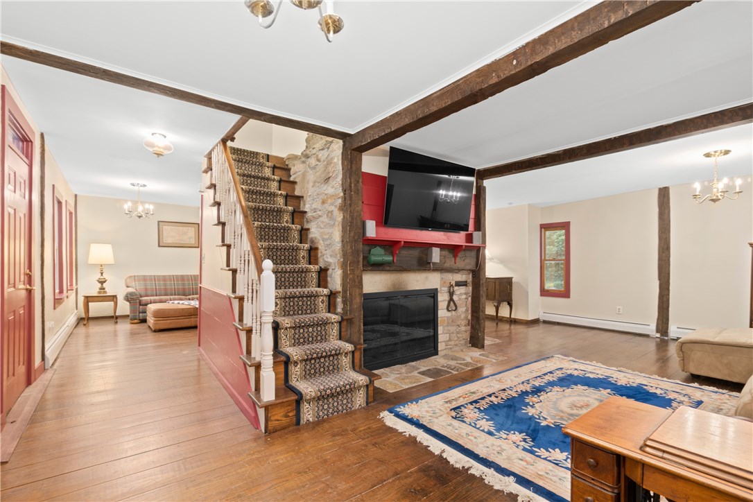 422 Waterman Hill Road Coventry, RI 02827 - Photo 15 of 39 Front stairs lead to 2 upper bedrooms and full bathroom. Living room with one of six stone fireplaces.