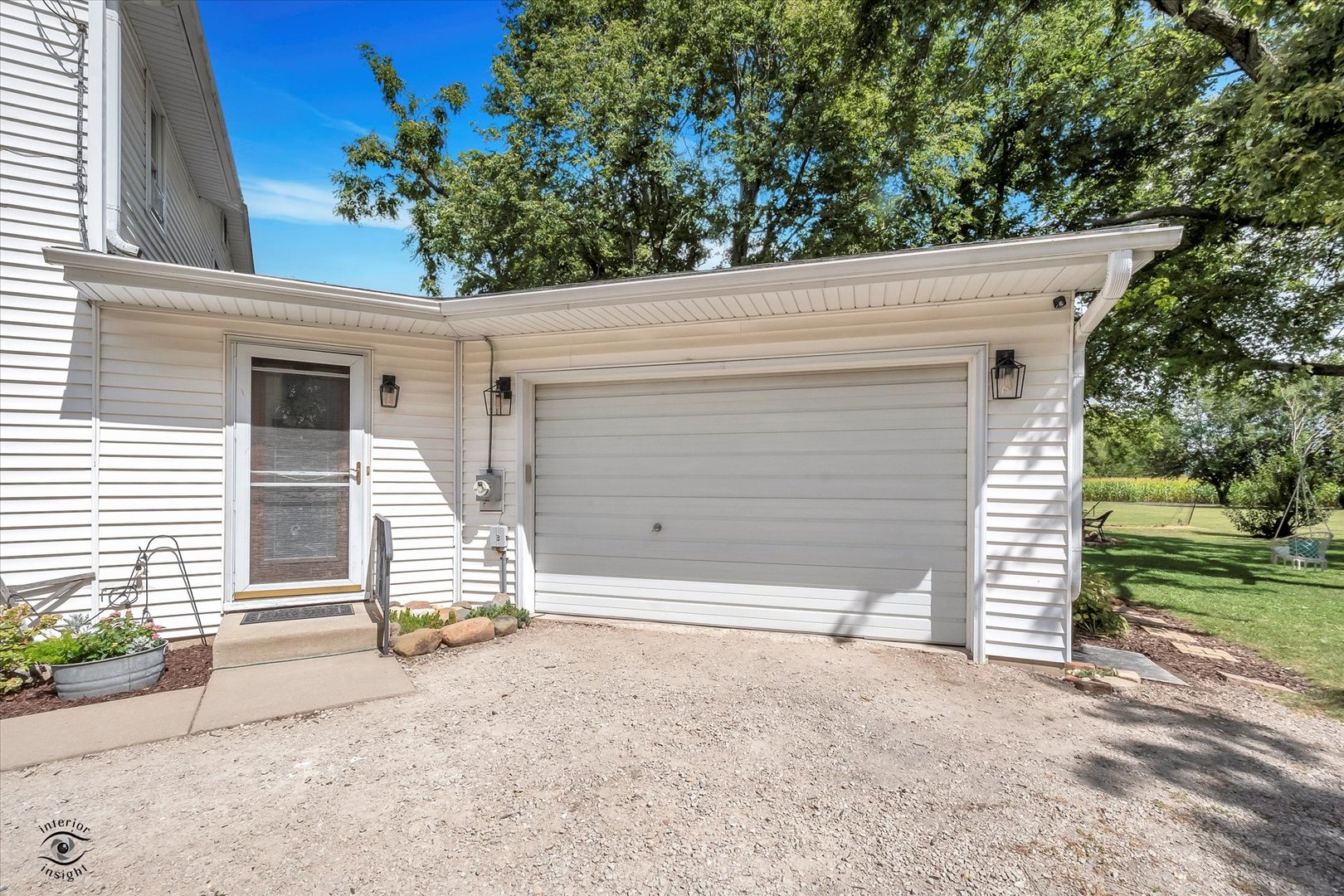 12022 Lisbon Road Newark, IL 60541 - Photo 26 of 28 a view of a small house with a yard and garage