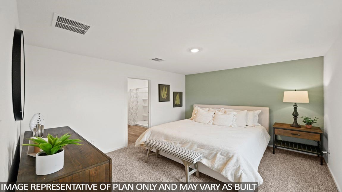 20004 Fibonacci Street New Caney, TX 77357 - Photo 8 of 21 a bedroom with a bed a mirror and a potted plant