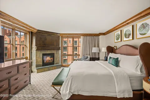 a bed room with a bed and a fireplace