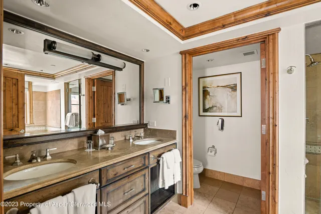 a bathroom with 2 sink and a mirror