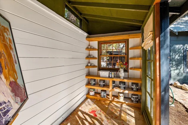 a view of balcony with wooden floor and outdoor seating