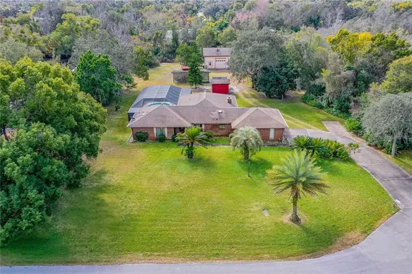 an aerial view of residential houses with outdoor space