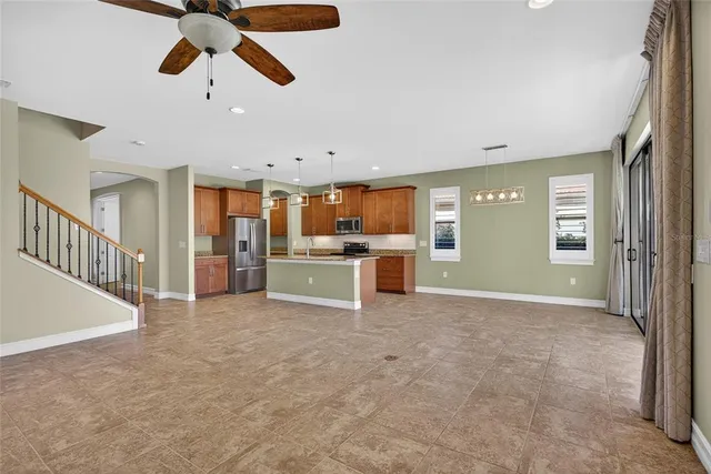 a view of an empty room with window and cabinet