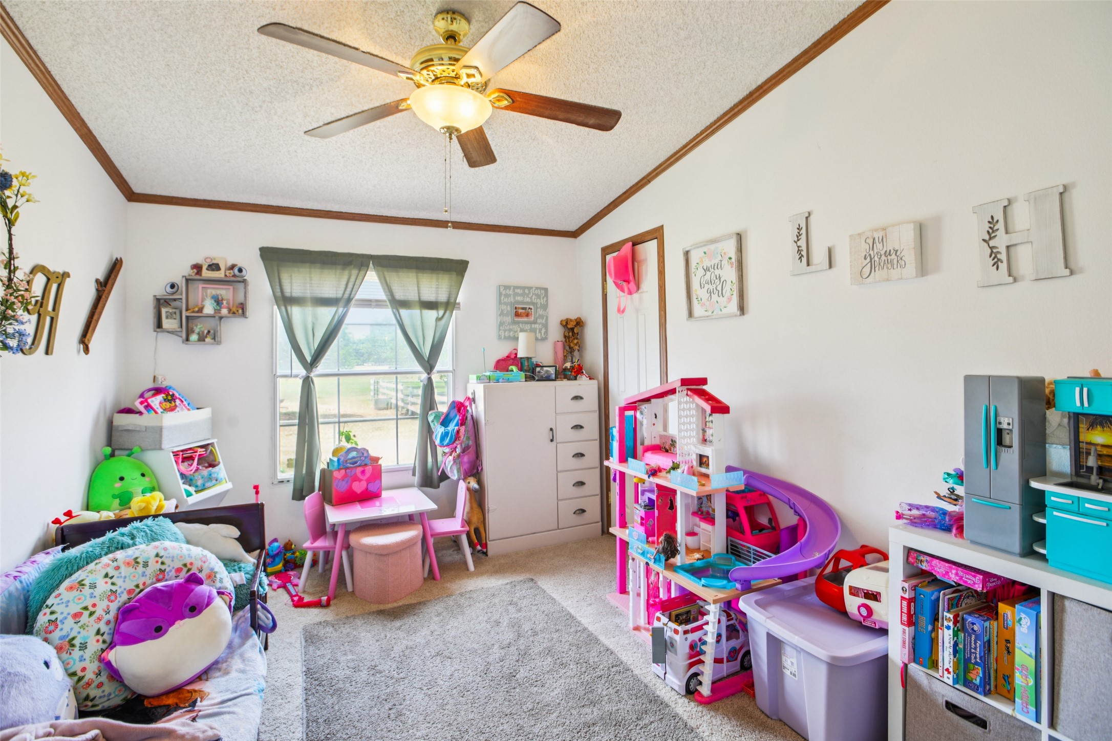 372 Hofferek Road Rosanky, TX 78953 - Photo 21 of 40 Playroom with a textured ceiling, carpet, crown molding, and ceiling fan