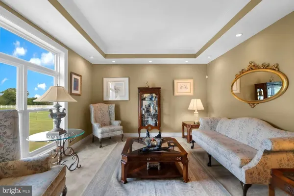 a living room with furniture a mirror and a window