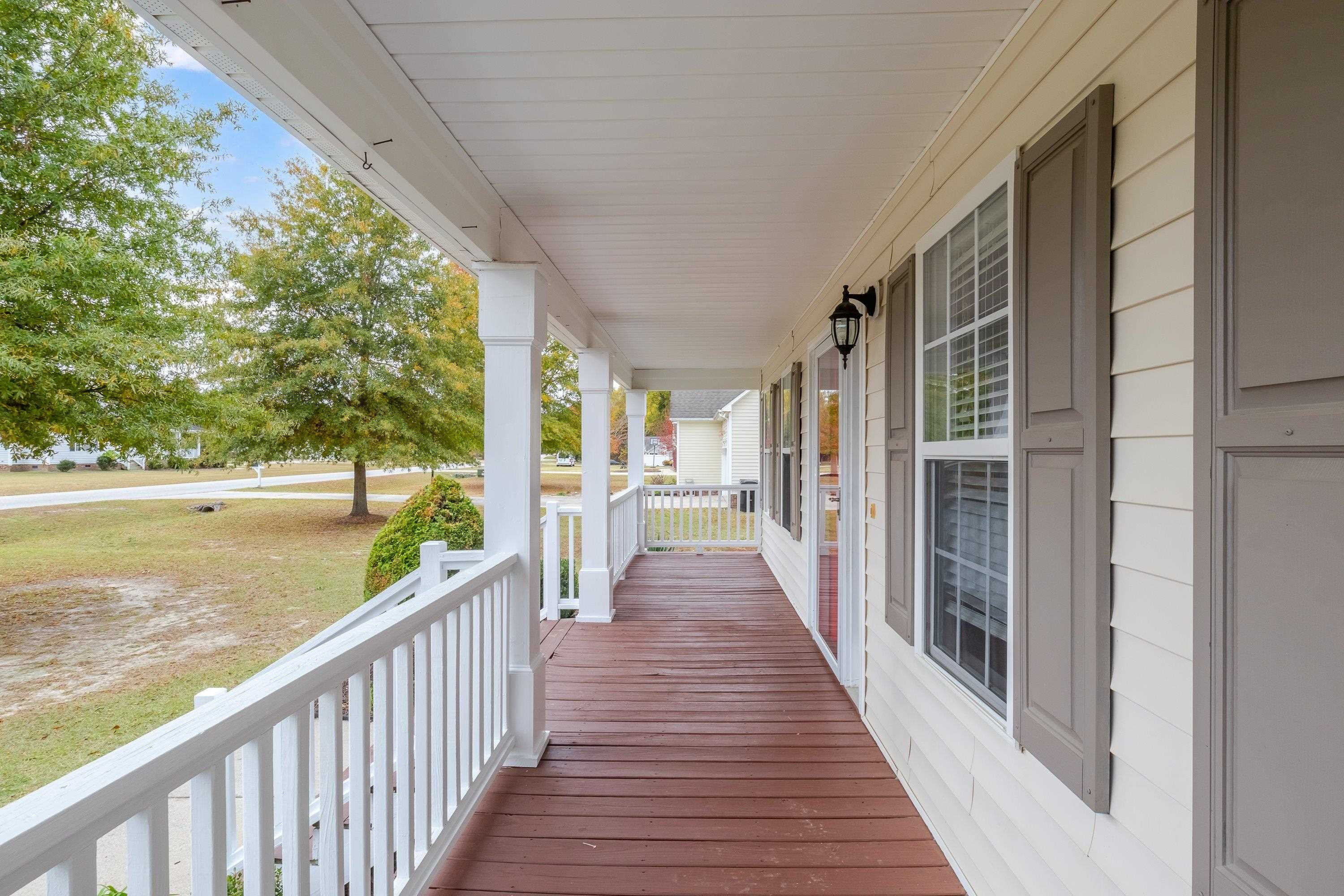 345 Axum Road Willow Spring, NC 27592 - Photo 7 of 38 Rocking Chair front porch