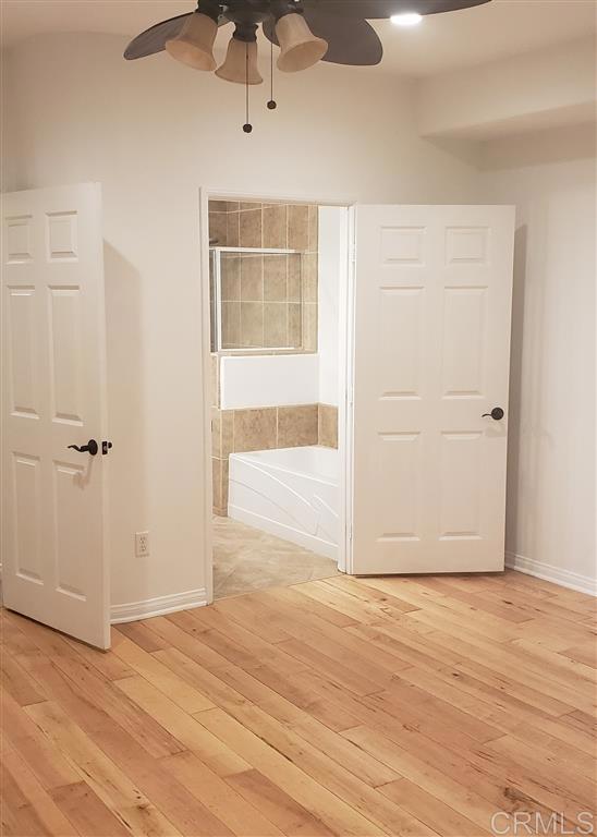 366 Forward Street, Unit E La Jolla, CA 92037 - Photo 13 of 26 an empty room with wooden floor cabinet and windows