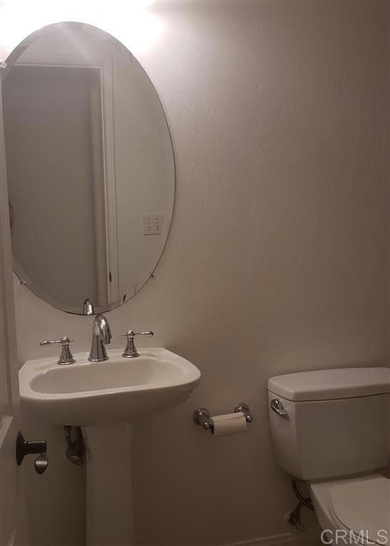 366 Forward Street, Unit E La Jolla, CA 92037 - Photo 18 of 26 a bathroom with a sink toilet and a mirror