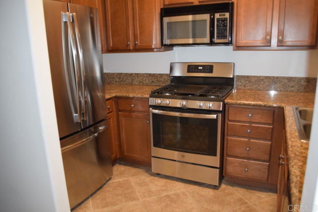 366 Forward Street, Unit E La Jolla, CA 92037 - Photo 2 of 26 a kitchen with granite countertop cabinets and steel stainless steel appliances